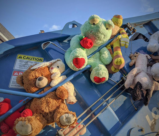 stuffed animals on a garbage truck
